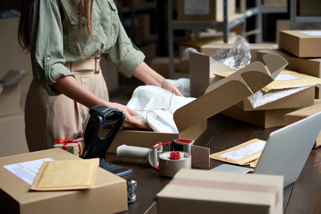 A woman packing an E-commerce order.