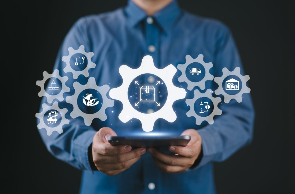Businessperson using digital tablet with logistics icons overlaid, representing automation and supply chain technology integration
